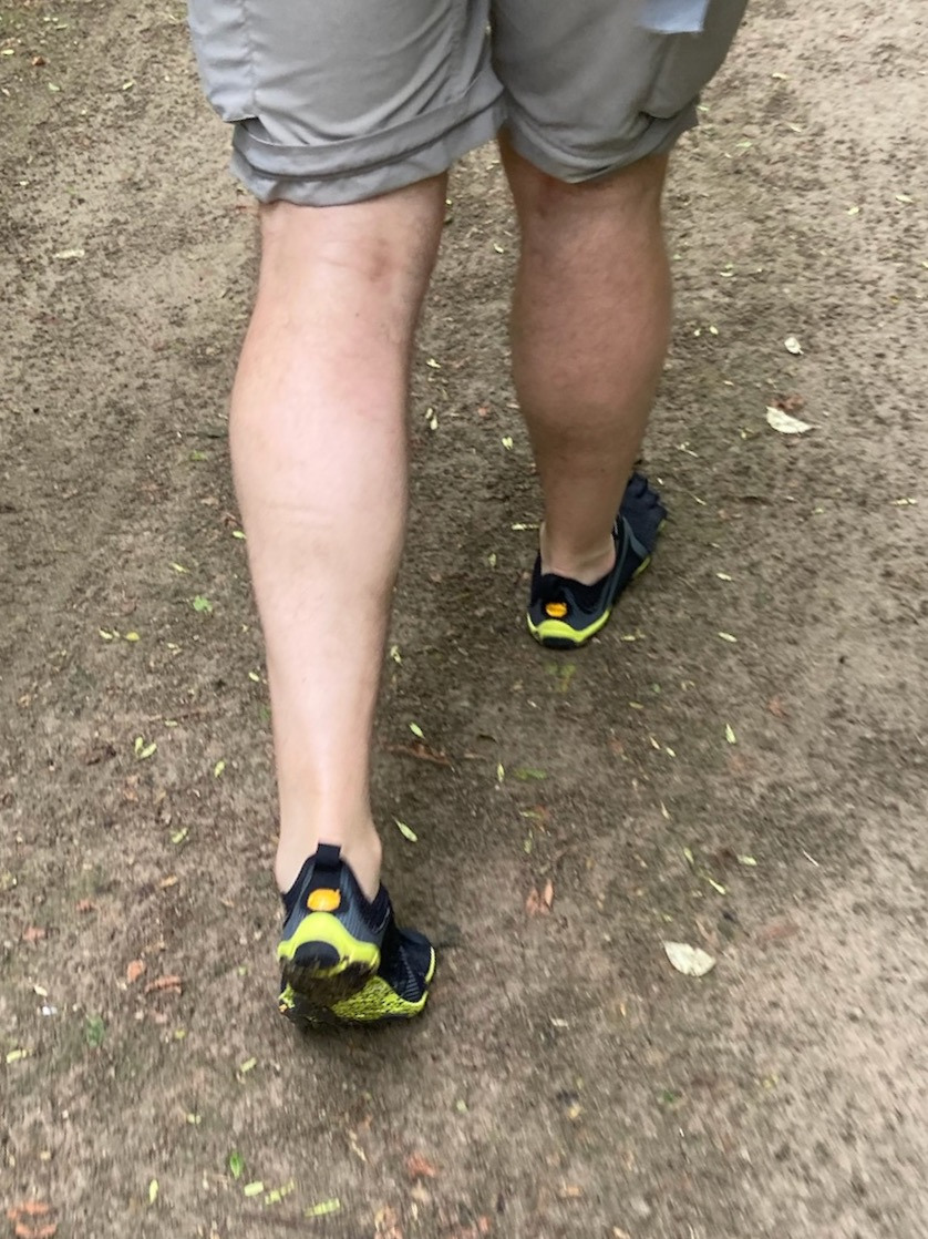 walking in vibram toe shoes shot from behind